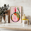 Bold black and orange kitchen-themed design with abstract shapes - styled on a counter with eucalyptus and a bowl of lemons