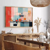 A colorful kitchen scene with orange and blue tones - in a Parisian living room with a sofa and a fig plant