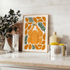 A colorful kitchen scene with greens and oranges, featuring utensils and food items - styled on a counter with eucalyptus and a bowl of lemons