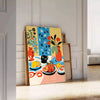Abstract kitchen scene with orange and blue tones - leaning on a herringbone floor against a white panelled wall