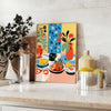 Abstract kitchen scene with orange and blue tones - styled on a counter with eucalyptus and a bowl of lemons
