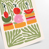 A colorful kitchen print featuring shades of green and orange