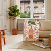 Contemporary kitchen scene with bold orange and gray tones - in a Parisian living room with a sofa and a fig plant