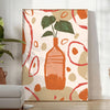 Contemporary kitchen scene with bold orange and gray tones - in a bright minimalist room with a plant and an armchair