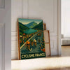Tour de France cycling poster with minimalist gray and green illustration - leaning on a herringbone floor against a white panelled wall
