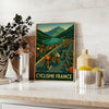 Tour de France cycling poster with minimalist gray and green illustration - styled on a counter with eucalyptus and a bowl of lemons