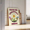 A groovy poster featuring bold yellow and black colors with a space theme and motivational text. - leaning on a herringbone floor against a white panelled wall