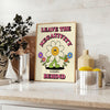 A groovy poster featuring bold yellow and black colors with a space theme and motivational text. - styled on a counter with eucalyptus and a bowl of lemons