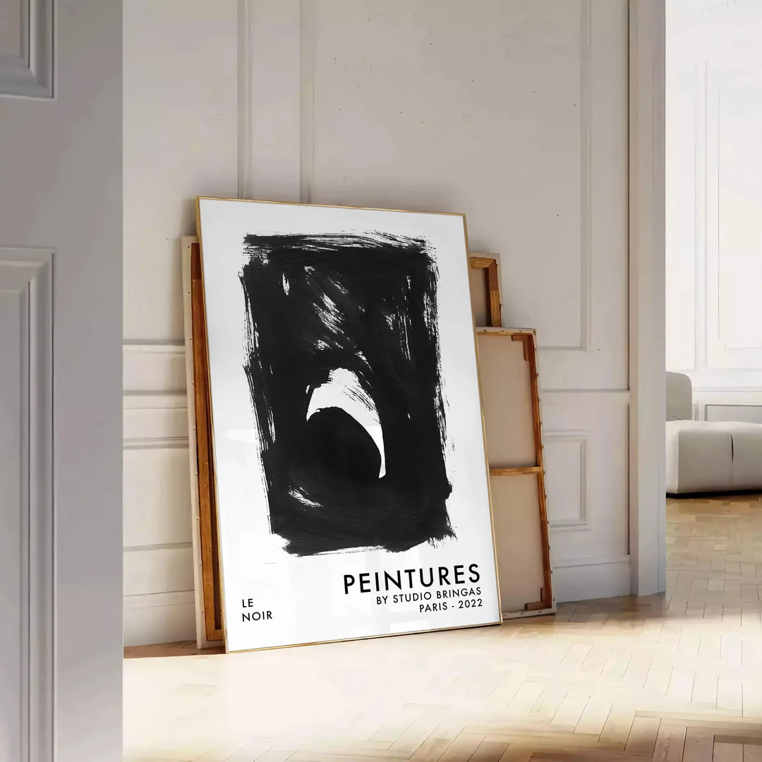 Maximalist poster featuring abstract space elements in black and blue tones - leaning on a herringbone floor against a white panelled wall