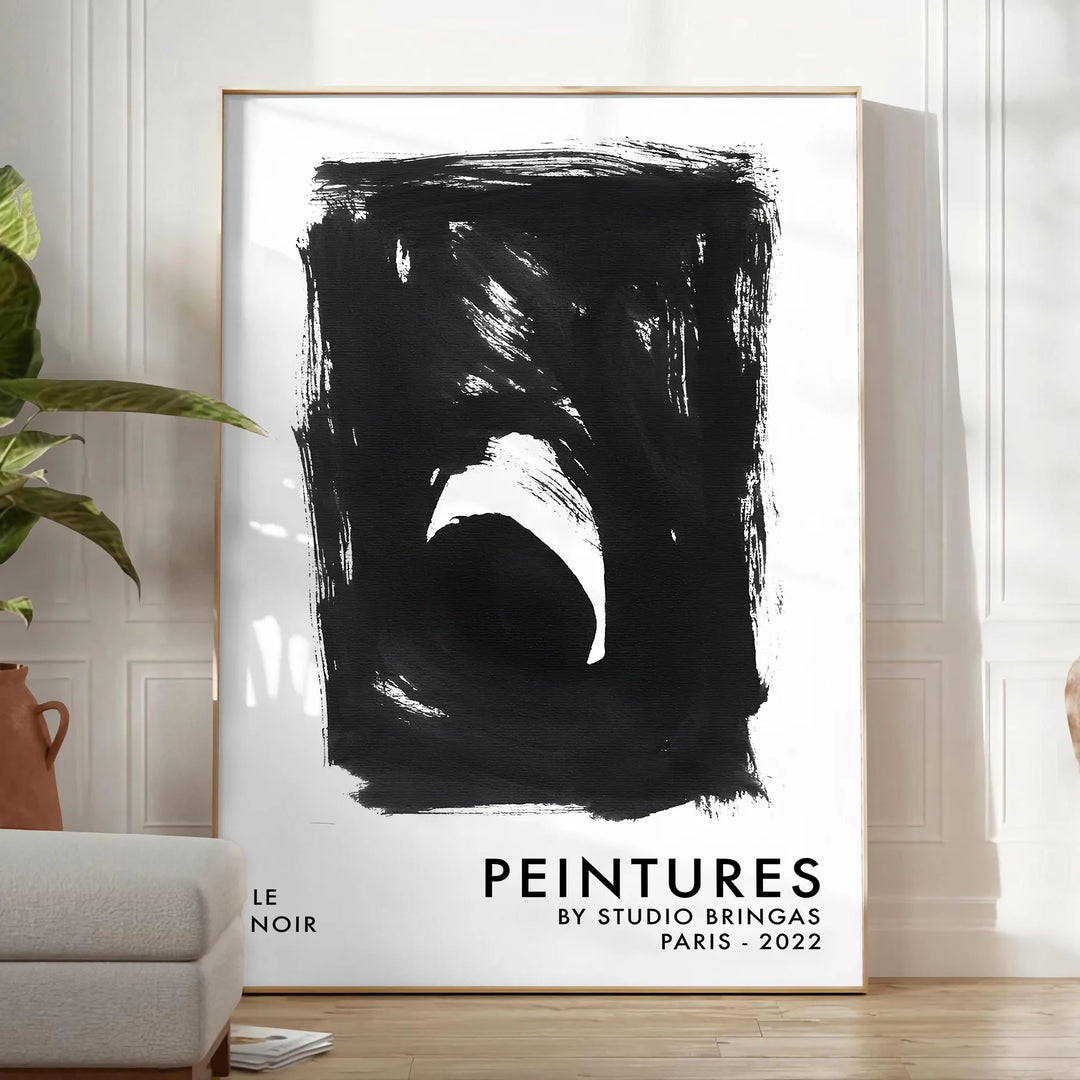 Maximalist poster featuring abstract space elements in black and blue tones - in a bright minimalist room with a plant and an armchair