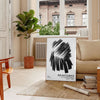 Maximalist wall art featuring bold black and blue hues - in a Parisian living room with a sofa and a fig plant