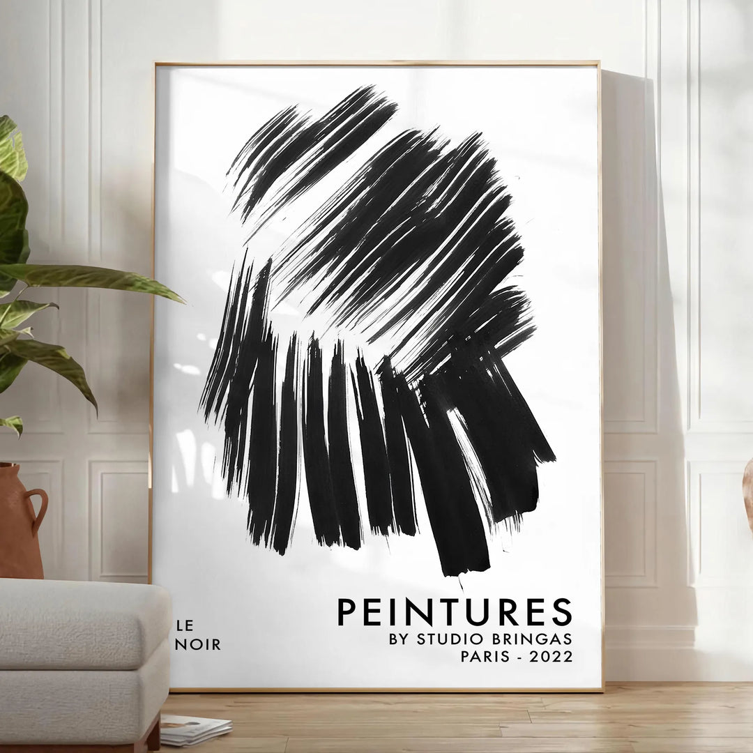 Maximalist wall art featuring bold black and blue hues - in a bright minimalist room with a plant and an armchair