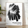 Maximalist wall art featuring bold black and blue hues - in a bright minimalist room with a plant and an armchair