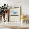 Vintage illustration of animals by Les Lalanne in muted gray and green tones - styled on a counter with eucalyptus and a bowl of lemons