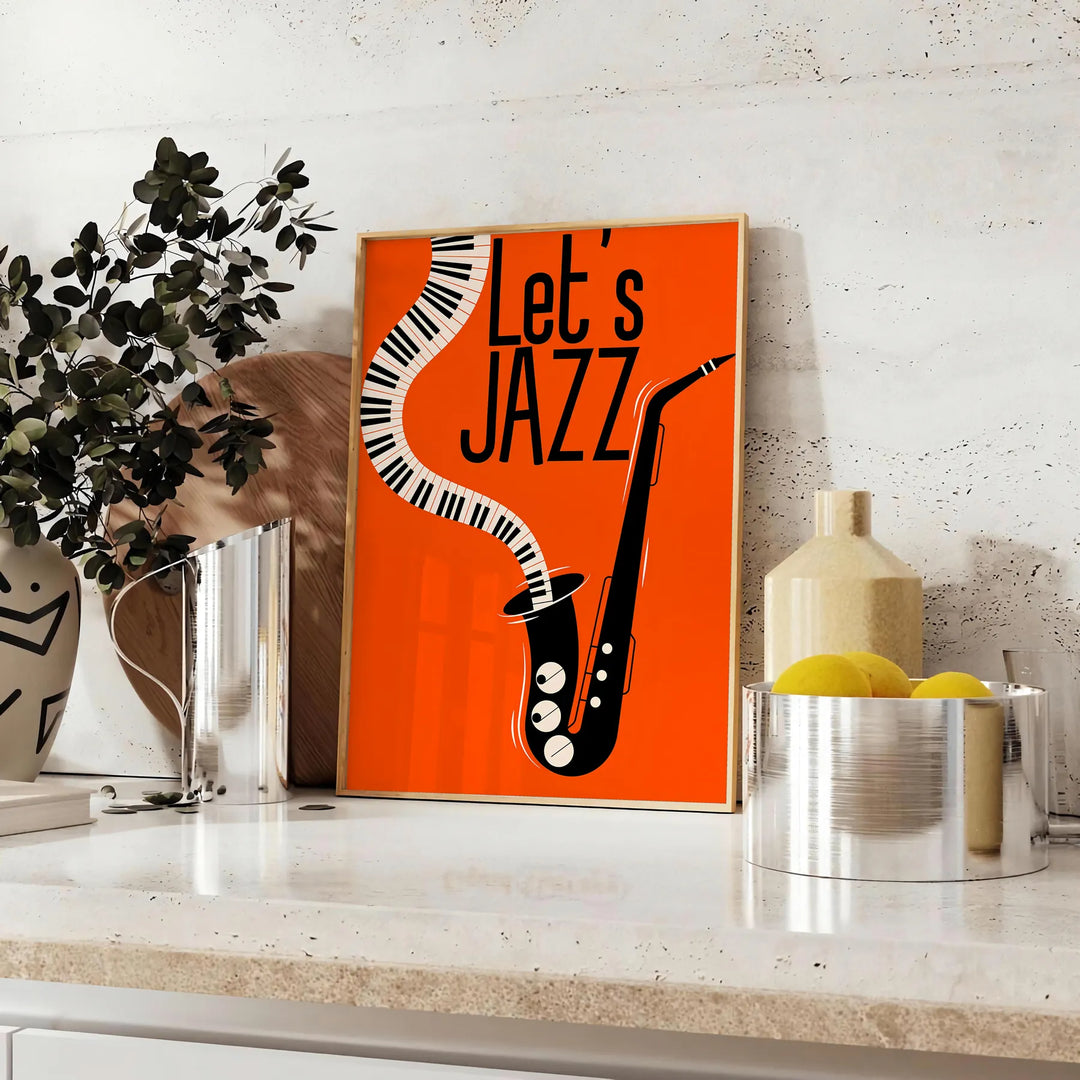 Maximalist poster featuring bold orange and black abstract shapes with jazz elements - styled on a counter with eucalyptus and a bowl of lemons