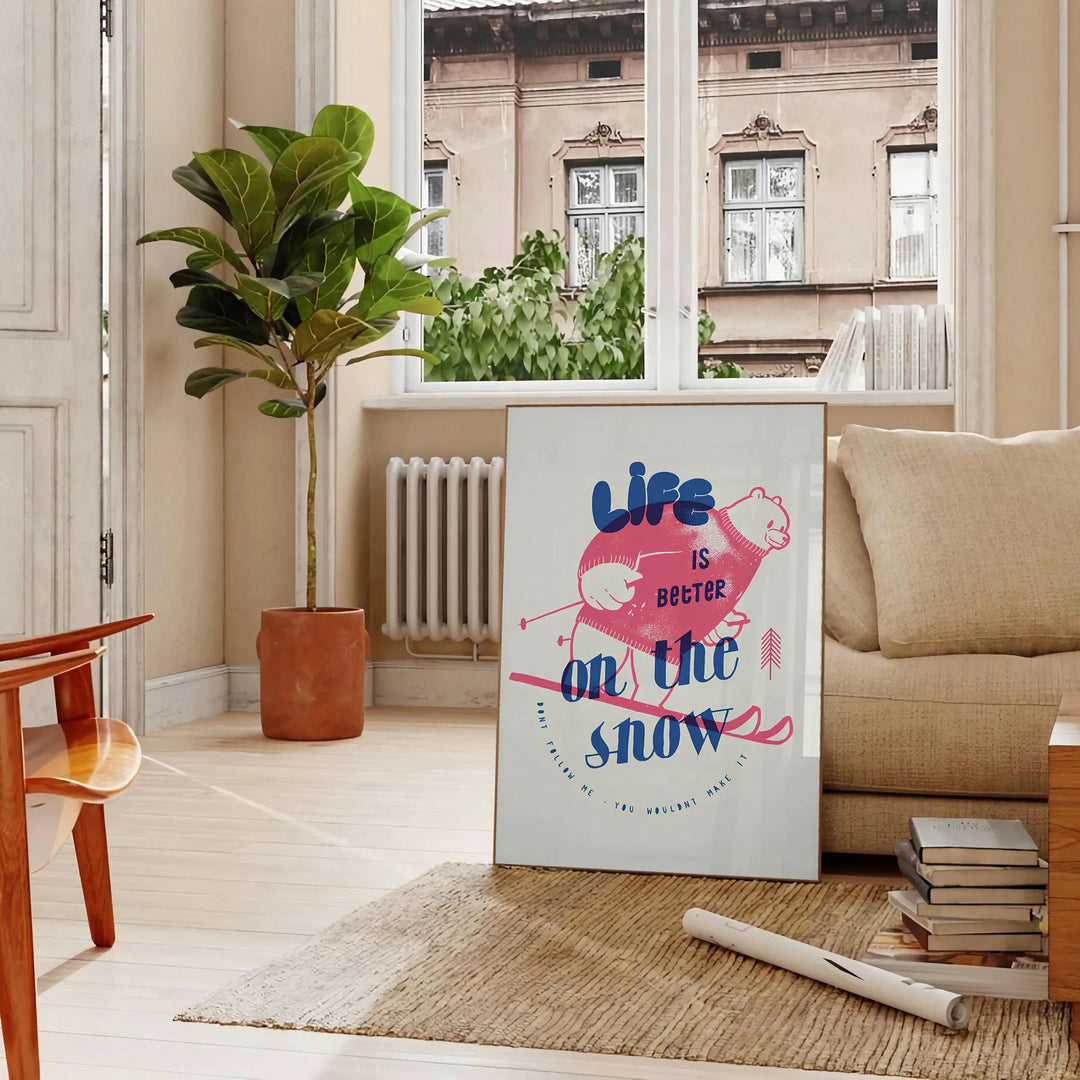 Maximalist poster featuring a snowy landscape with bold blue and white colors - in a Parisian living room with a sofa and a fig plant