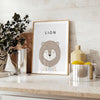 A realistic lion portrait in shades of gray and black - styled on a counter with eucalyptus and a bowl of lemons