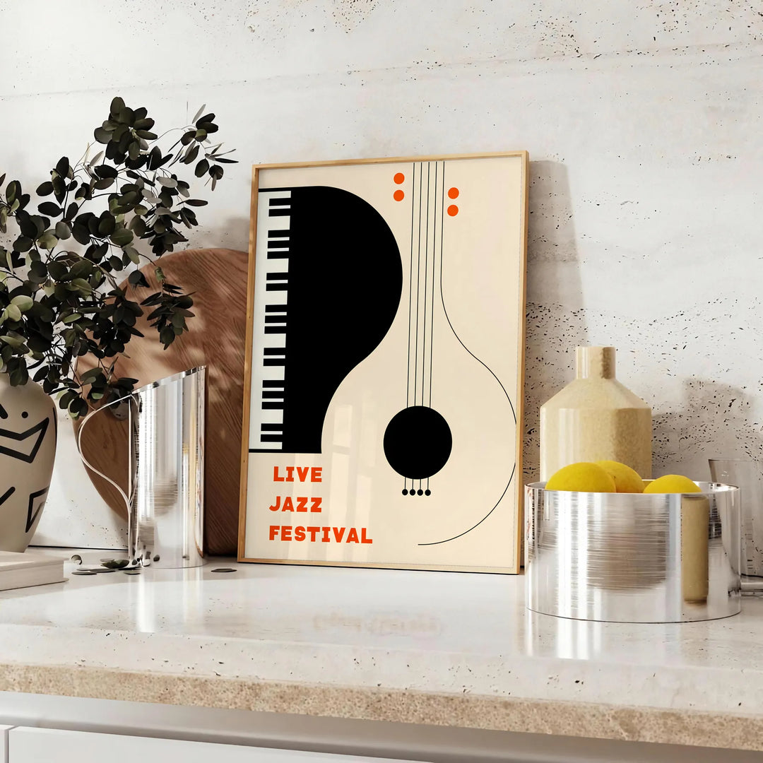 Maximalist print featuring an abstract depiction of a jazz festival with orange and black tones - styled on a counter with eucalyptus and a bowl of lemons