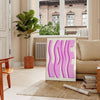 Abstract design featuring pink and purple hues with motivational text - in a Parisian living room with a sofa and a fig plant