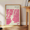 Stylized map of New York City in black and gray tones - beside a round wooden side table with books