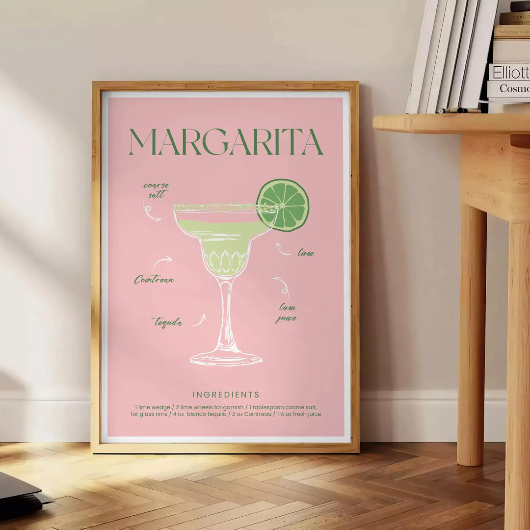 Uma ilustração colorida de um coquetel Margarita com tons verdes e laranjas - ao lado de uma mesa de apoio redonda em madeira com livros