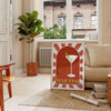A colorful illustration of a martini cocktail with green and orange accents - in a Parisian living room with a sofa and a fig plant