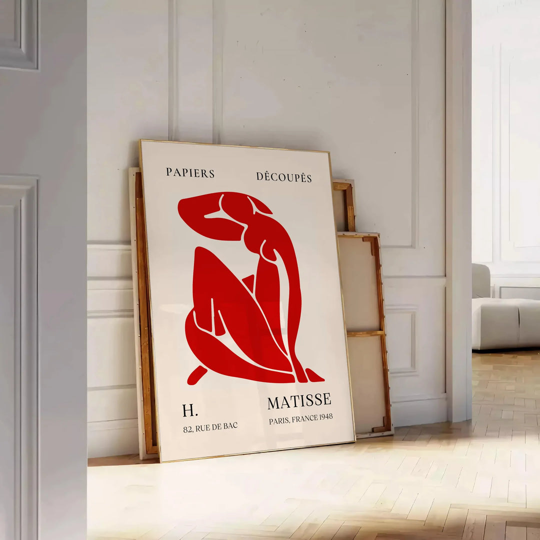 Abstract shapes and bold colors in Matisse style - leaning on a herringbone floor against a white panelled wall
