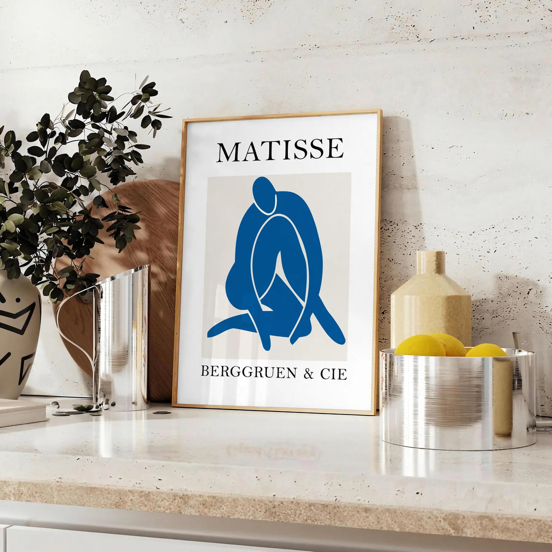 Gray and white Matisse papier découpés poster with abstract organic shapes - styled on a counter with eucalyptus and a bowl of lemons