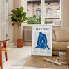 Gray and white Matisse papier découpés poster with abstract organic shapes - in a Parisian living room with a sofa and a fig plant