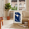 Gray and white cut-out shapes in Matisse's papier découpés style - in a Parisian living room with a sofa and a fig plant