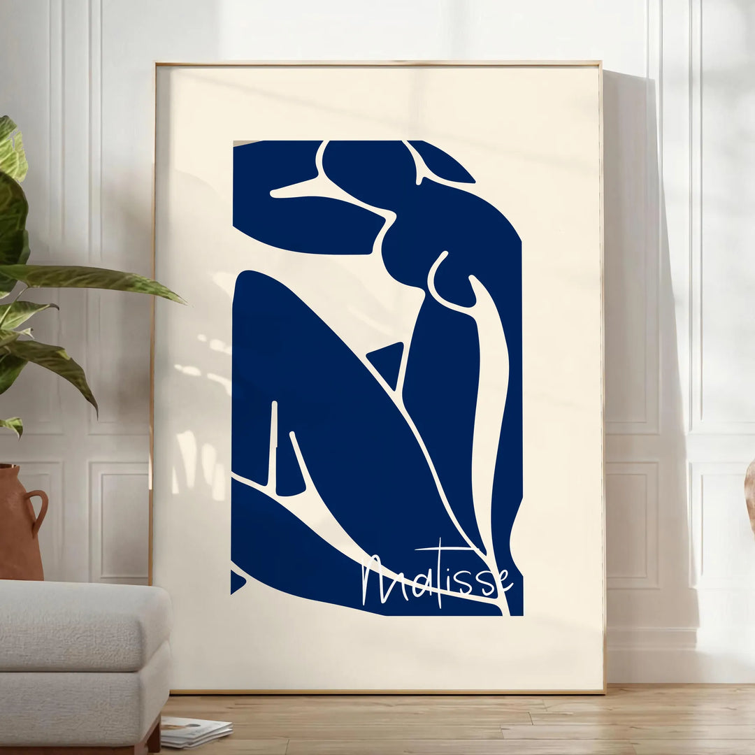 Gray and white cut-out shapes in Matisse's papier découpés style - in a bright minimalist room with a plant and an armchair