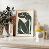 Gray and white poster of Matisse paper cut abstract shapes, minimalist. - styled on a counter with eucalyptus and a bowl of lemons