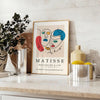 Abstract cut-paper composition in white and yellow by Matisse - styled on a counter with eucalyptus and a bowl of lemons