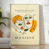 Poster of Matisse-style papier découpé abstract composition, bold organic shapes - in a bright minimalist room with a plant and an armchair