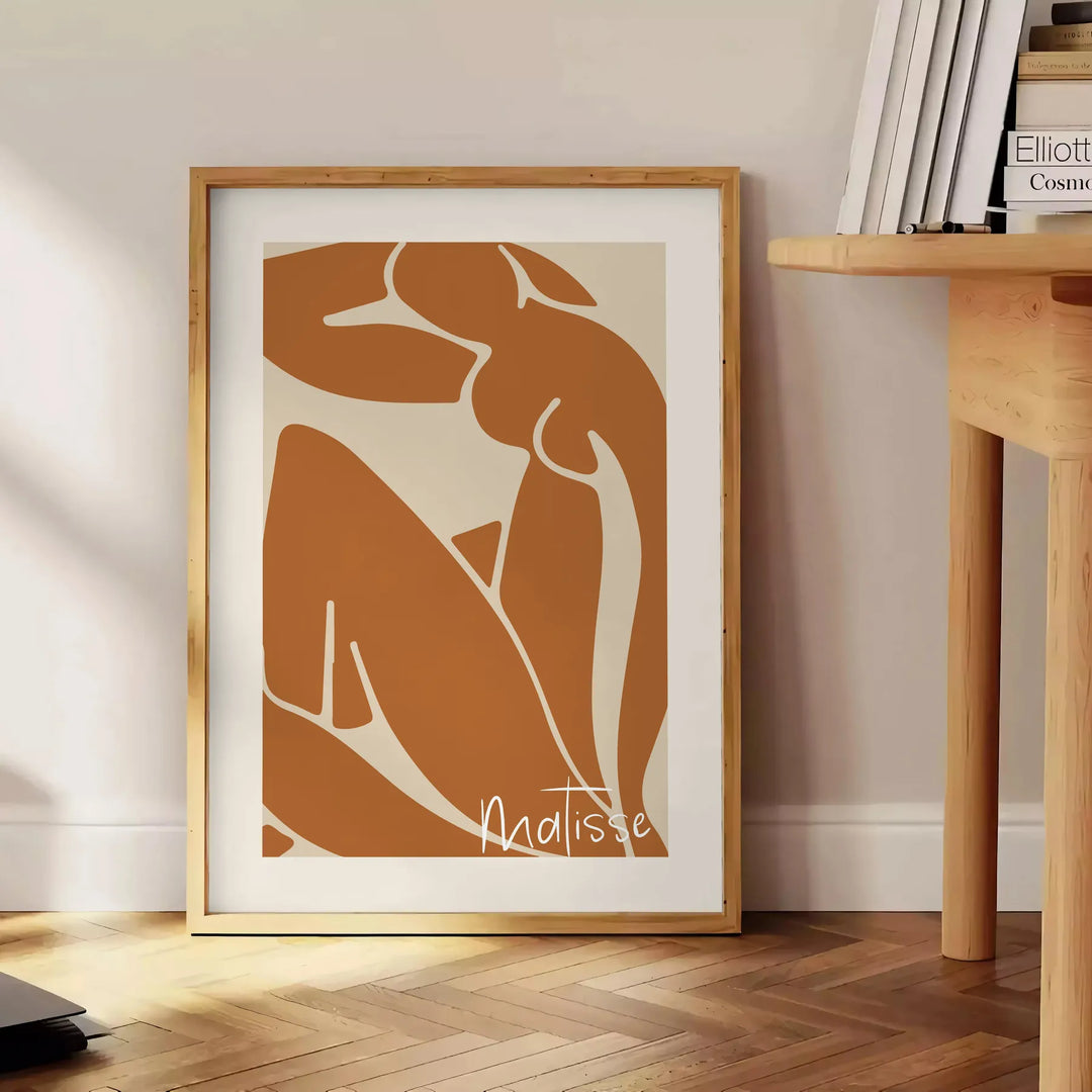 Colorful abstract cut-out shapes in the style of Matisse - beside a round wooden side table with books