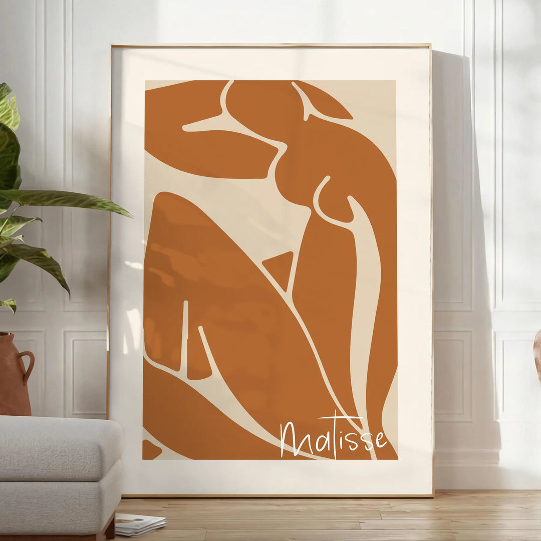 Colorful abstract cut-out shapes in the style of Matisse - in a bright minimalist room with a plant and an armchair