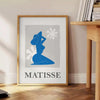Poster Matisse di ritagli di carta con composizione astratta organica - accanto a un tavolino rotondo in legno con libri