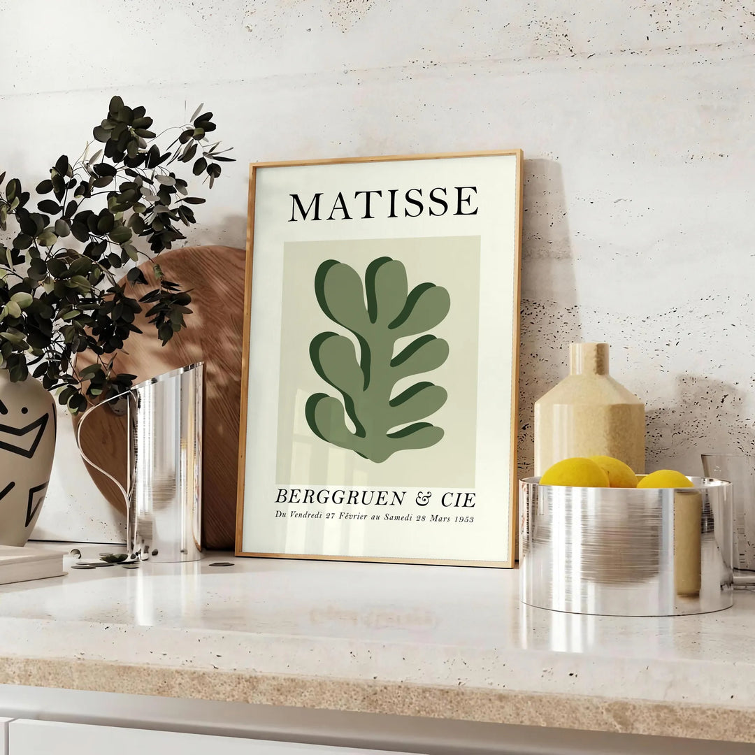 Matisse papier découpés poster with gray and white abstract cutout shapes - styled on a counter with eucalyptus and a bowl of lemons