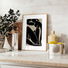 Poster showing Matisse-style abstract cut-out shapes in bold colors - styled on a counter with eucalyptus and a bowl of lemons