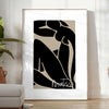 Poster showing Matisse-style abstract cut-out shapes in bold colors - in a bright minimalist room with a plant and an armchair