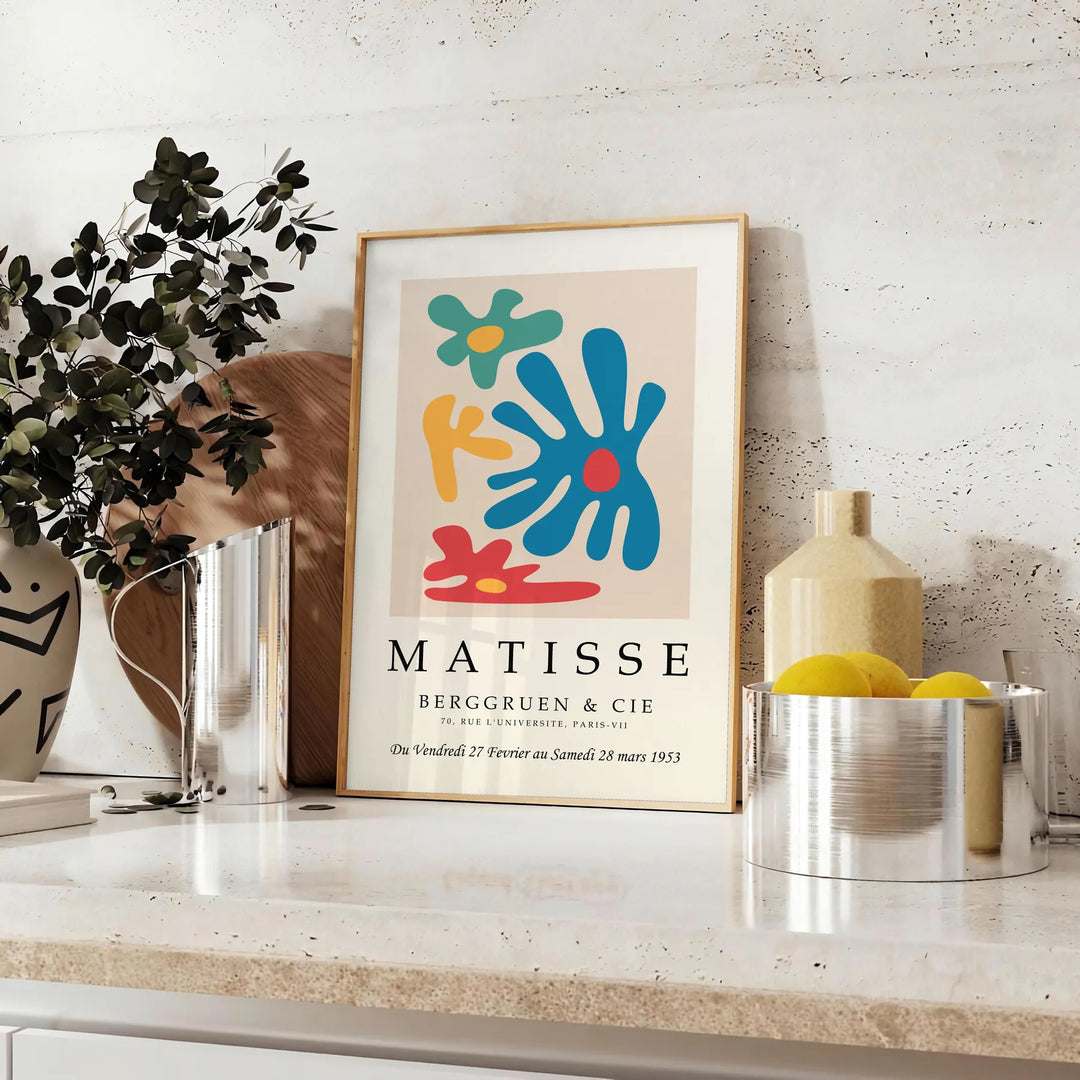 Abstract cut-out design in white and yellow by Matisse - styled on a counter with eucalyptus and a bowl of lemons