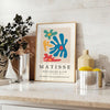 Abstract cut-out design in white and yellow by Matisse - styled on a counter with eucalyptus and a bowl of lemons