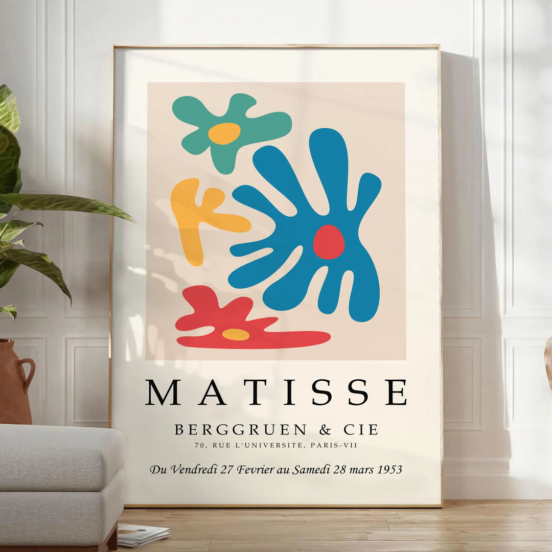 Abstract cut-out design in white and yellow by Matisse - in a bright minimalist room with a plant and an armchair