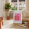 Abstract cut-paper collage by Matisse featuring gray and red shapes - in a Parisian living room with a sofa and a fig plant