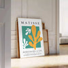 Abstract gray and white cut paper composition by Matisse - leaning on a herringbone floor against a white panelled wall