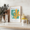 Abstract gray and white cut paper composition by Matisse - styled on a counter with eucalyptus and a bowl of lemons