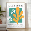 Abstract gray and white cut paper composition by Matisse - in a bright minimalist room with a plant and an armchair