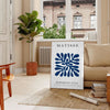 Poster of Matisse-style paper cutout composition in white and green - in a Parisian living room with a sofa and a fig plant