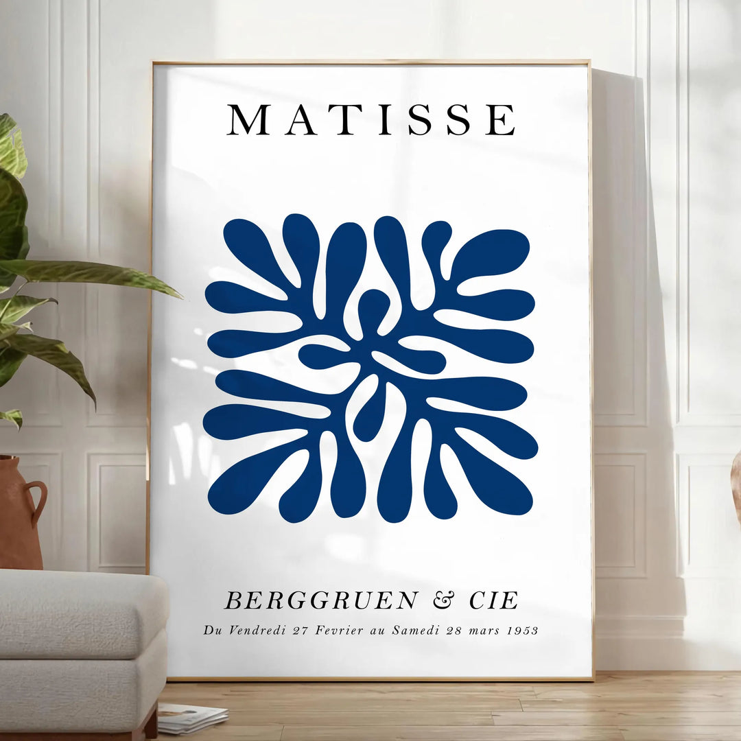 Poster of Matisse-style paper cutout composition in white and green - in a bright minimalist room with a plant and an armchair