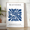 Poster of Matisse-style paper cutout composition in white and green - in a bright minimalist room with a plant and an armchair